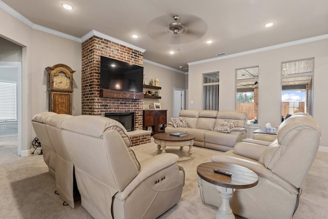 living room featuring a brick fireplace, ornamental molding, light colored carpet, and ceiling fan