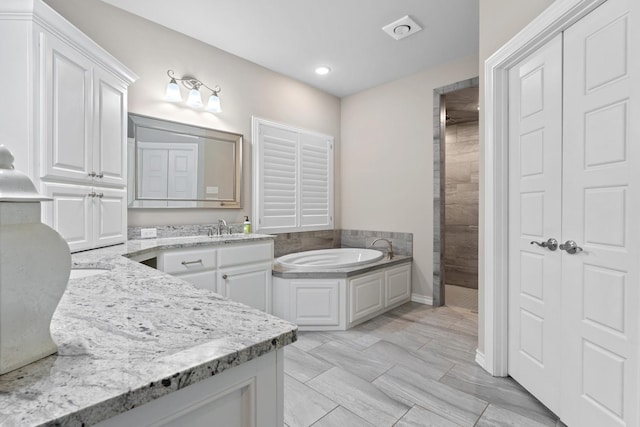 bathroom featuring vanity and a bathtub