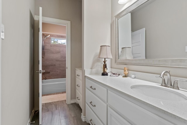 bathroom featuring shower / tub combination and vanity