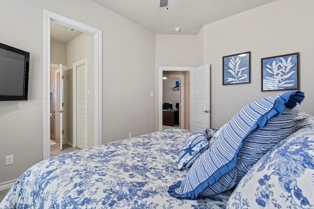 bedroom with a walk in closet and ceiling fan