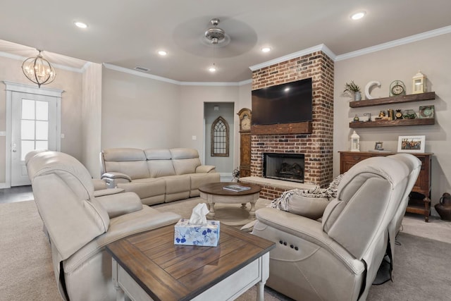 carpeted living room featuring crown molding, a fireplace, and ceiling fan with notable chandelier