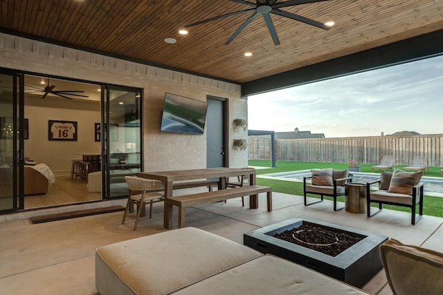 7722 47th St, Lubbock, TX 79407 - fenced backyard featuring ceiling fan, a patio area, outdoor dining space, and an outdoor living space with a fire pit