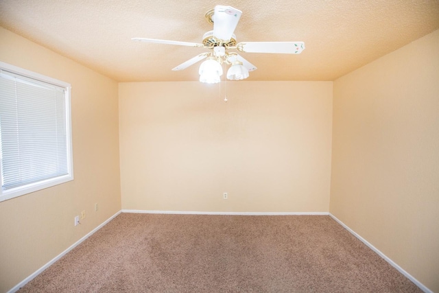 spare room featuring carpet, a textured ceiling, and ceiling fan