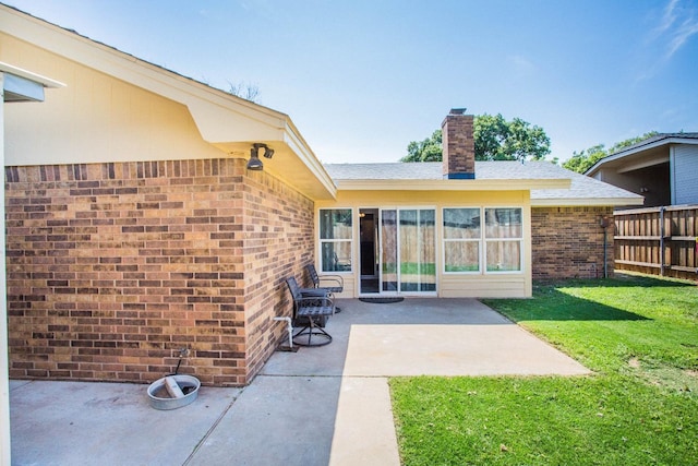 back of house featuring a yard and a patio area