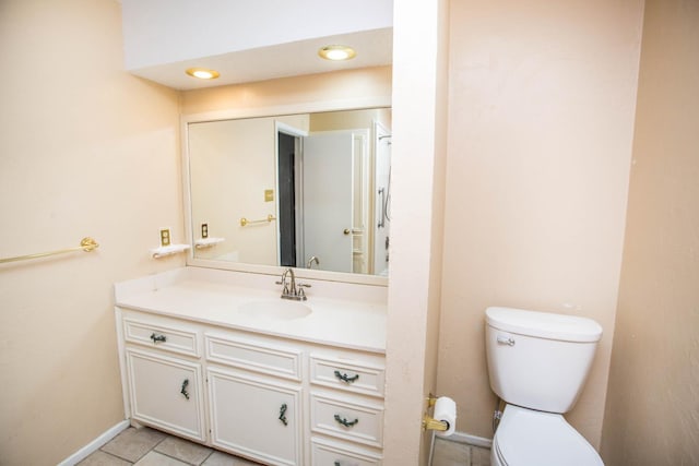 bathroom featuring vanity, tile patterned floors, and toilet