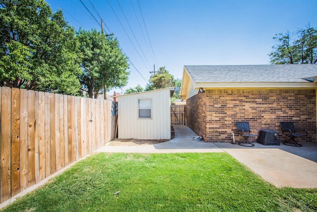 view of yard with an outdoor structure and a patio area