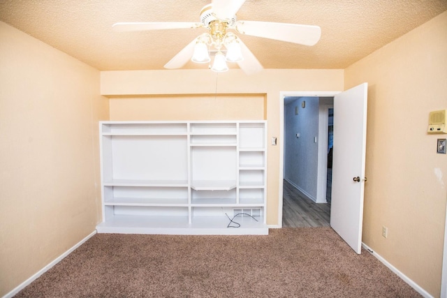 unfurnished bedroom featuring ceiling fan, a textured ceiling, and carpet