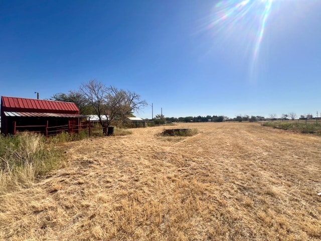 view of yard with a rural view