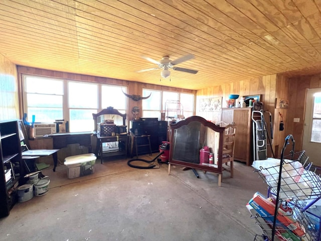 misc room with a healthy amount of sunlight, concrete floors, wood ceiling, and wood walls