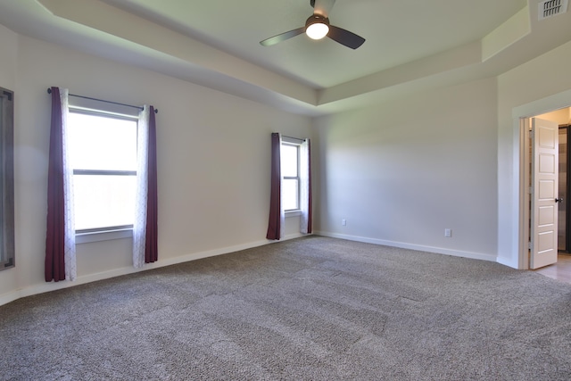 10504 Ave X, Lubbock, TX 79423 - unfurnished room featuring ceiling fan, carpet flooring, and a tray ceiling