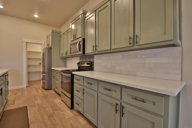 10504 Ave X, Lubbock, TX 79423 - kitchen with stainless steel appliances, decorative backsplash, light countertops, light wood-style flooring, and recessed lighting