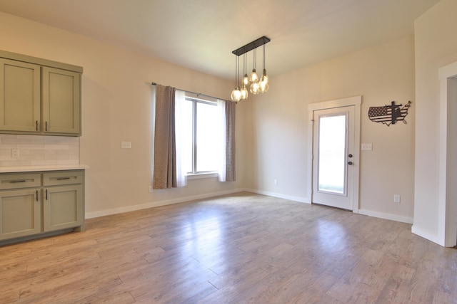 10504 Ave X, Lubbock, TX 79423 - unfurnished dining area with light wood-style flooring and a chandelier