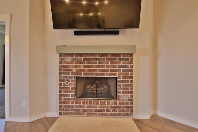 10504 Ave X, Lubbock, TX 79423 - detailed view of wood finished floors and a brick fireplace