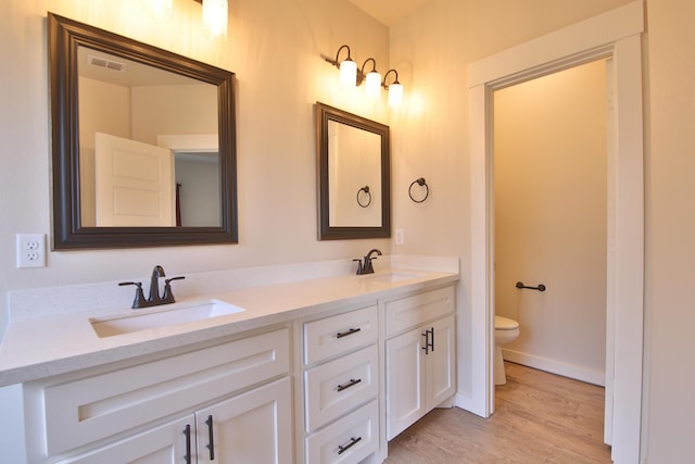 10504 Ave X, Lubbock, TX 79423 - bathroom featuring wood finished floors and double vanity