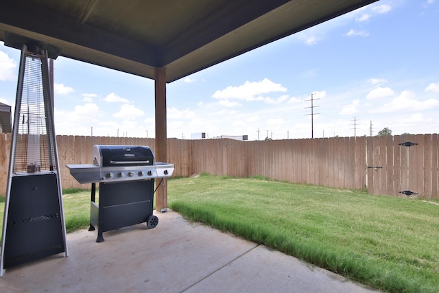 10504 Ave X, Lubbock, TX 79423 - fenced backyard with a grill and a patio area