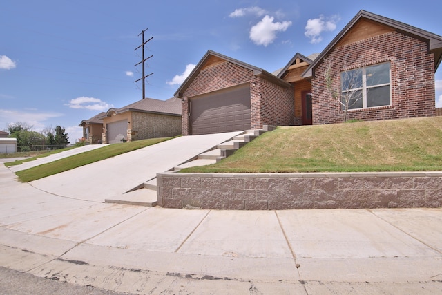 10504 Ave X, Lubbock, TX 79423 - ranch-style home featuring brick siding, driveway, a garage, and a front lawn