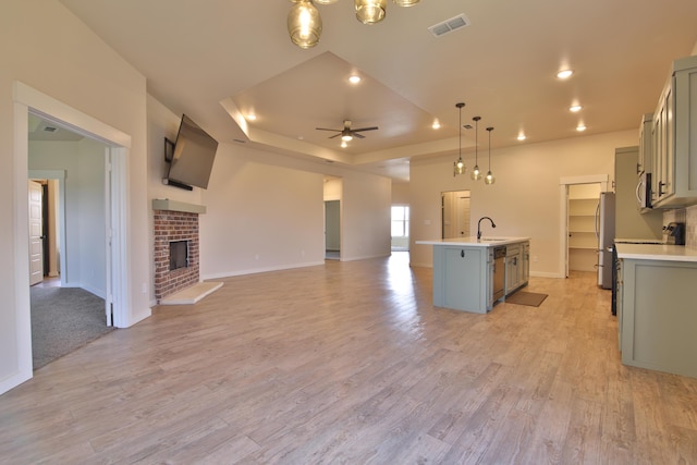 10504 Ave X, Lubbock, TX 79423 - kitchen with ceiling fan, gray cabinets, light countertops, stainless steel appliances, and a tray ceiling