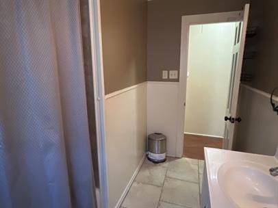 bathroom with tile patterned flooring and vanity