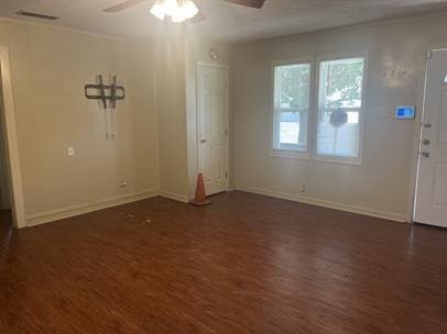 entrance foyer featuring crown molding, dark wood-type flooring, and ceiling fan