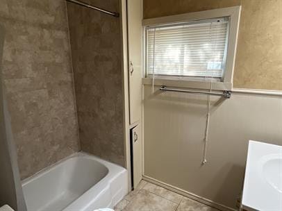 full bathroom featuring vanity, tile patterned flooring, tiled shower / bath combo, and toilet