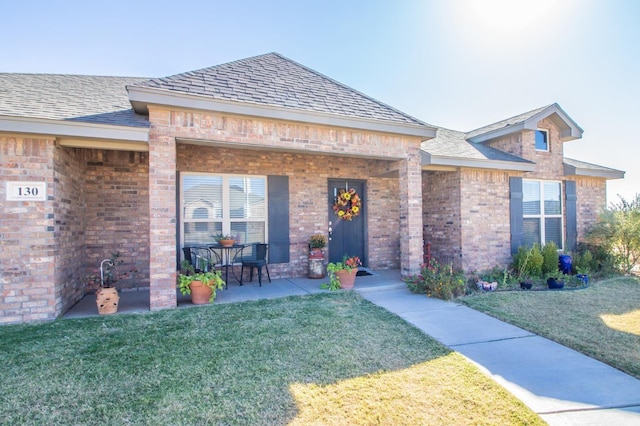 view of front of property with a patio area and a front lawn