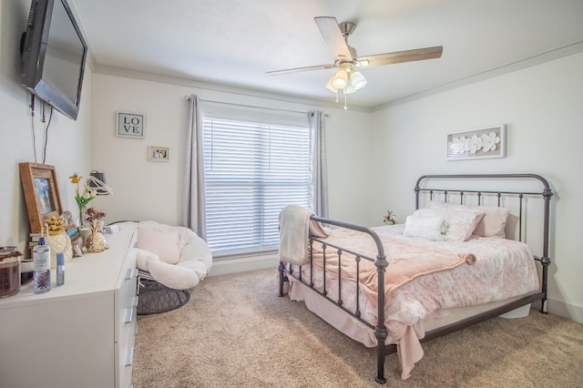 bedroom featuring crown molding, light colored carpet, and ceiling fan