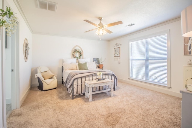 bedroom with crown molding, light colored carpet, and ceiling fan