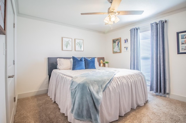 bedroom with multiple windows, ornamental molding, ceiling fan, and carpet flooring