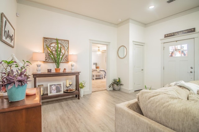 interior space featuring crown molding and light wood-type flooring