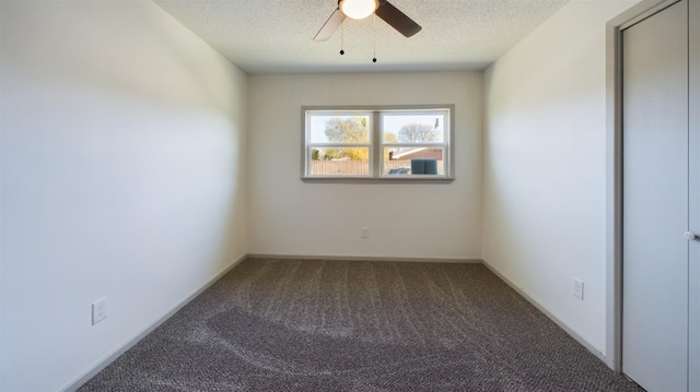 empty room featuring ceiling fan, carpet floors, and a textured ceiling