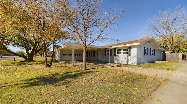 single story home featuring a carport and a front lawn