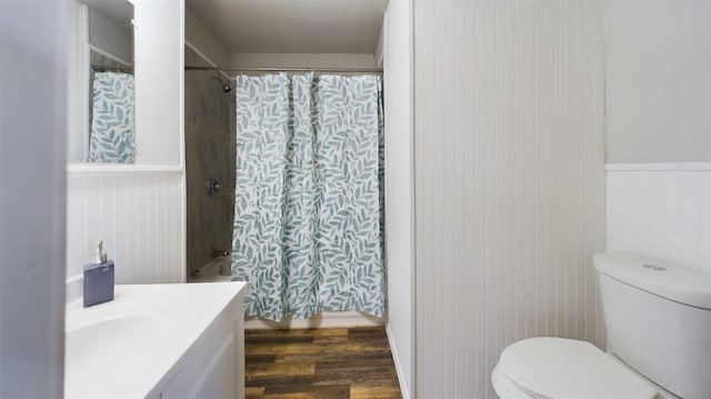 full bathroom featuring vanity, hardwood / wood-style flooring, toilet, and shower / bathtub combination with curtain