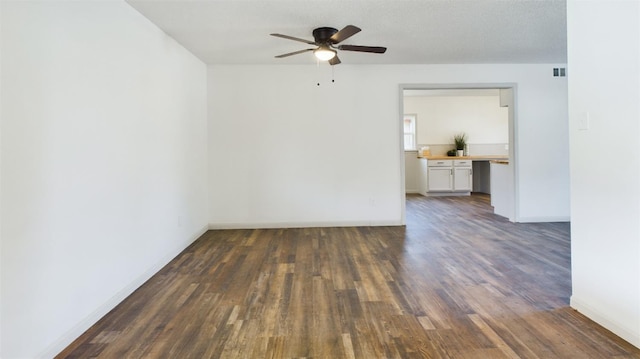 spare room featuring dark hardwood / wood-style floors, a textured ceiling, and ceiling fan