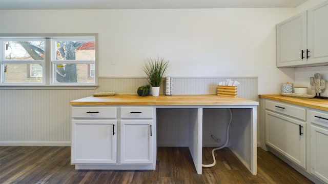 kitchen with dark hardwood / wood-style floors, white cabinets, and wood counters