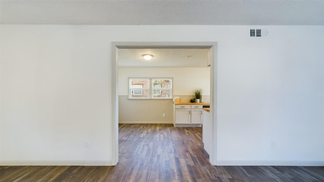 interior space with dark hardwood / wood-style floors and a textured ceiling