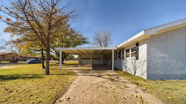 view of side of home with a carport and a yard