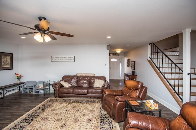 living room featuring decorative columns, hardwood / wood-style floors, and ceiling fan