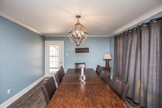 dining space with crown molding, dark hardwood / wood-style floors, and an inviting chandelier