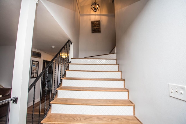 staircase with hardwood / wood-style flooring