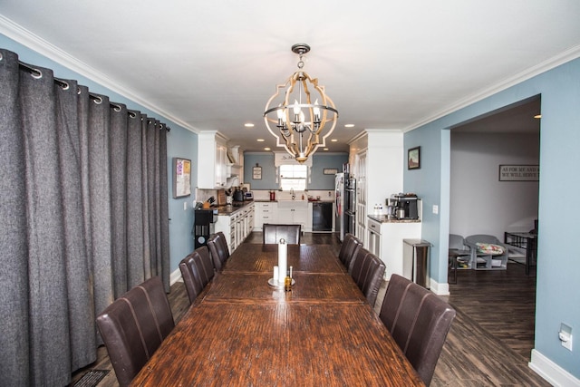 dining space with an inviting chandelier, ornamental molding, dark hardwood / wood-style floors, and sink