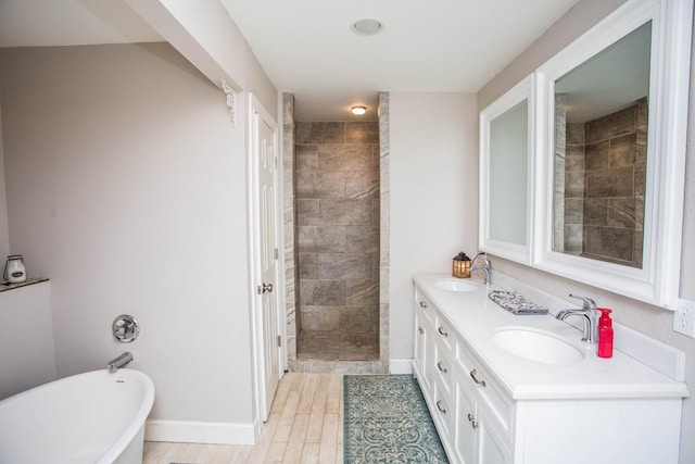 bathroom with vanity, separate shower and tub, and hardwood / wood-style floors