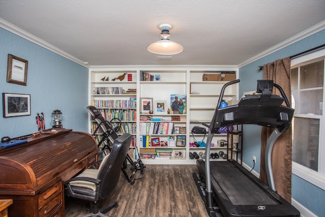 home office featuring wood-type flooring, ornamental molding, and a textured ceiling