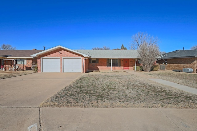 ranch-style home with cooling unit and a garage