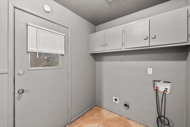 washroom featuring hookup for a washing machine, cabinets, light parquet flooring, and hookup for an electric dryer