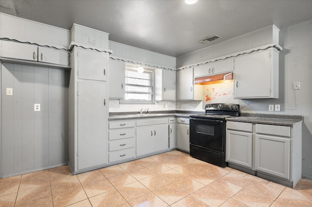 kitchen featuring gray cabinets, black electric range oven, sink, backsplash, and light tile patterned floors