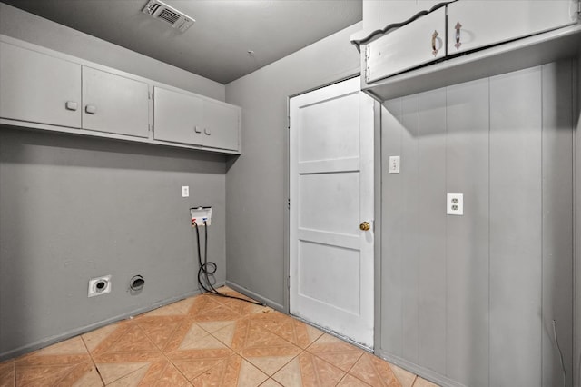 clothes washing area featuring cabinets, washer hookup, and hookup for an electric dryer