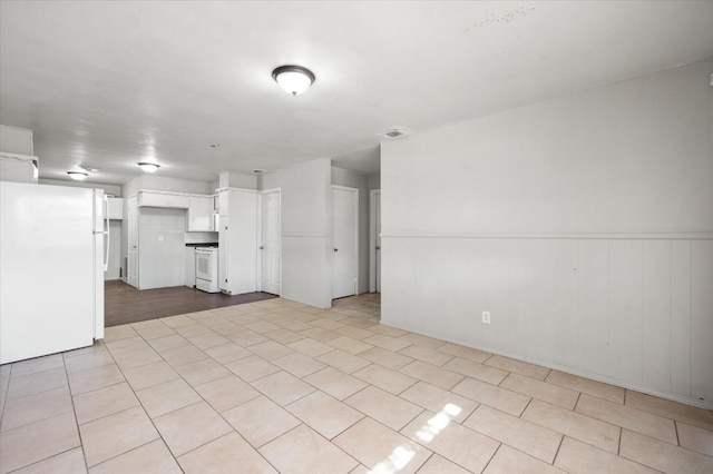 unfurnished living room with light tile patterned floors