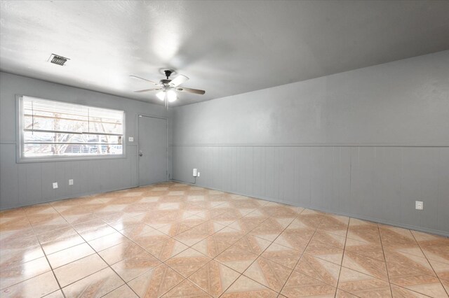 unfurnished room featuring ceiling fan and light tile patterned flooring