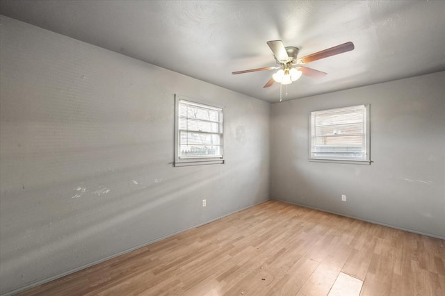 spare room with ceiling fan and light hardwood / wood-style flooring