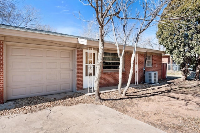 single story home featuring central AC and a garage